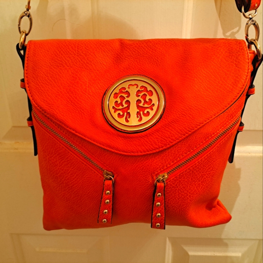 Orange crossbody purse. Took tags off but never wore it.